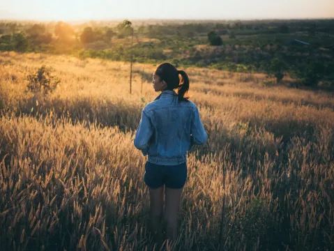 Person walking outdoors during recovery and return to normal activity