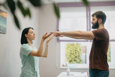 Healthcare professional assessing movement during sciatica recovery